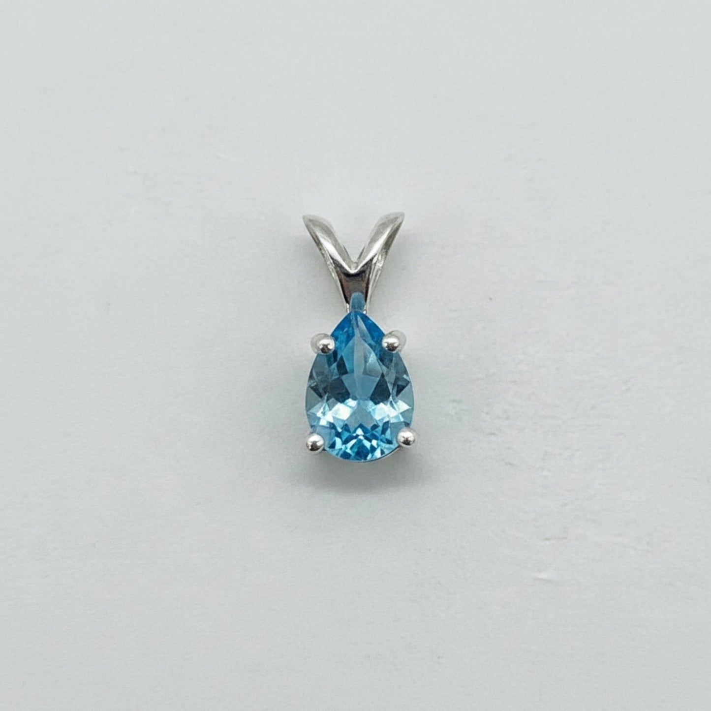 Custom gemstone pendant (shown in light blue topaz)